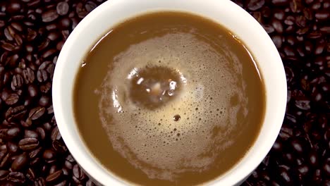 milk dripping into a cup of coffee slow motion