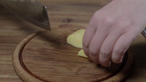 man cutting potatoes. no face, close up