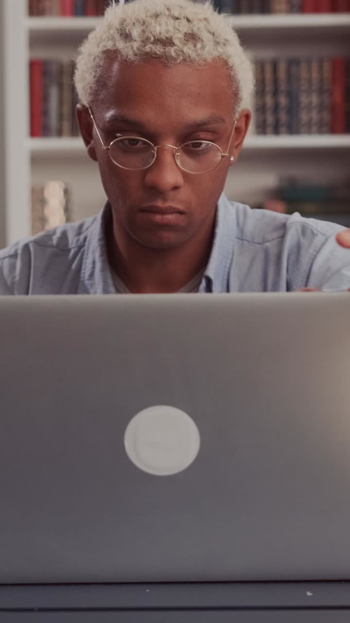 Focused individual writing at a desk in a cozy indoor space