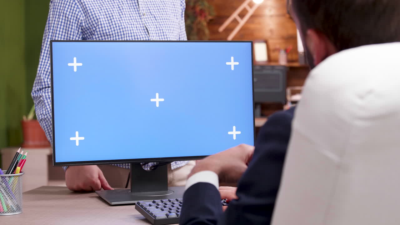 Working at a computer with a blue screen