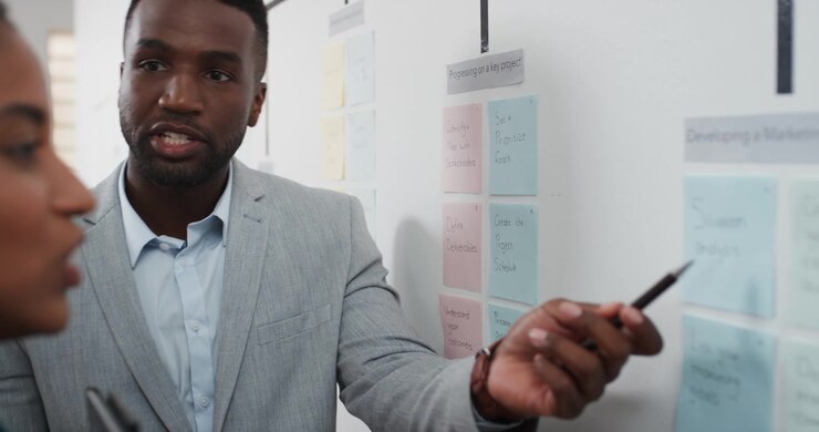 Professional Man Explaining Project Strategy to Colleague in Office
