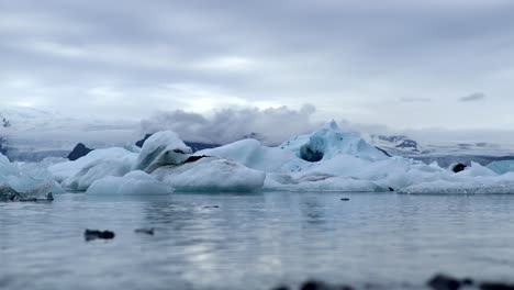 ice rocks swimming in water at jökulsárlón glacier in iceland, 4k