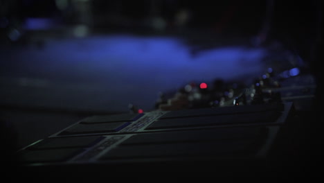 a close up of a guitarist's pedal board at a concert