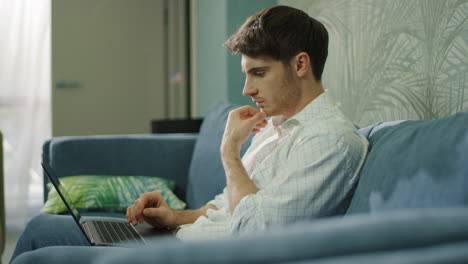 man typing computer in hotel room