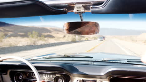 Young-black-woman-driving-with-her-friend-in-an-open-top-car