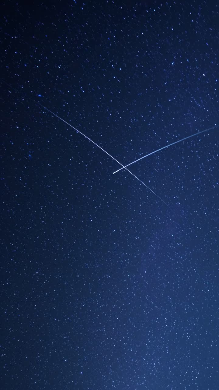 A mesmerizing video still of a starry night sky, captured from a low-angle perspective