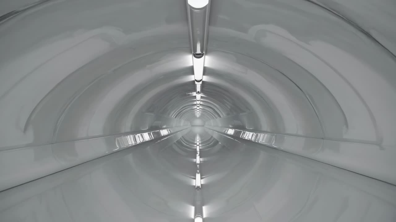 Futuristic tunnel scene showcases sleek design and illuminated pathway, emphasizing motion and depth in a continuous flow of light and space