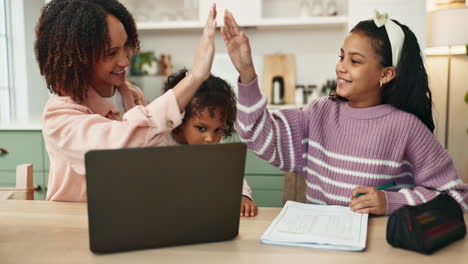 mother helping her daughters with homework