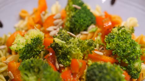 healthy colorful veggie pasta ready for serving - close up