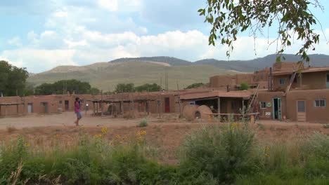 A-Native-American-Indian-girl-walks-near-the-Taos-pueblo-New-Mexico