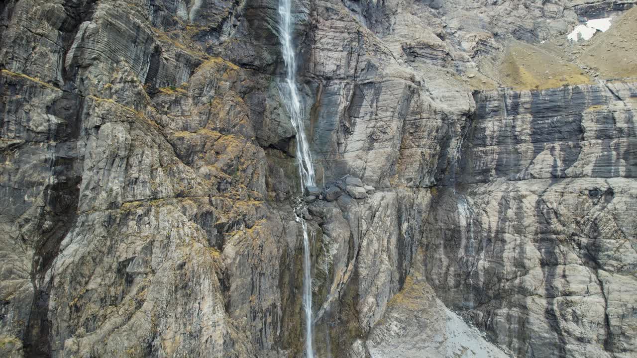 Gavarnie Falls cascades in a dramatic rocky cirque, zooming out perspective
