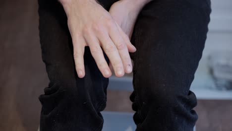 close-up of anxious caucasian man's nervous gestures and shaking hands