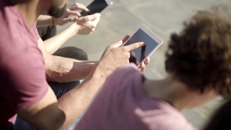 High angle view of young man using tablet