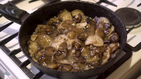 honey mushrooms are fried in oil in a frying pan 02