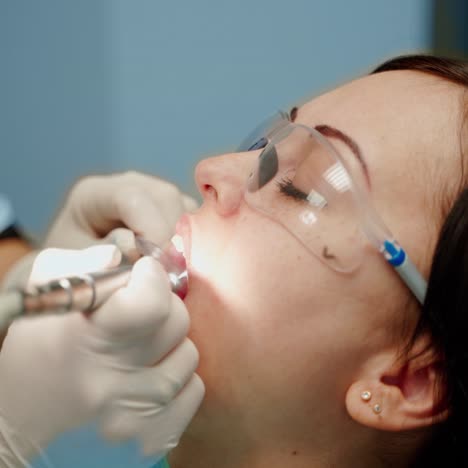 . doctor treats patient teeth. attractive young woman in stomatology clinic with dentist
