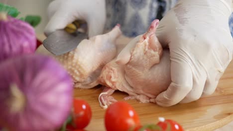 woman cutting up chicken for dinner