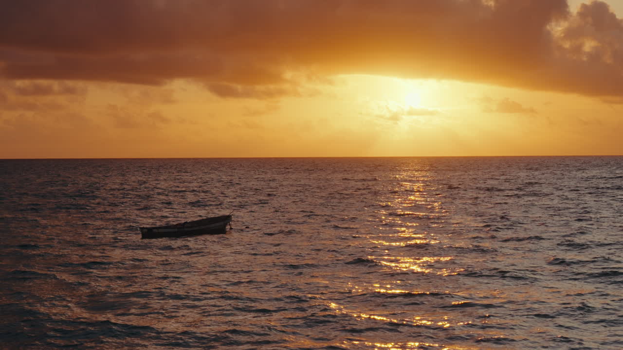 Sunrise over the Ocean with a small boat