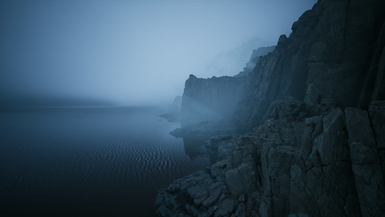 Mystical coastal cliffs shrouded in fog at dusk