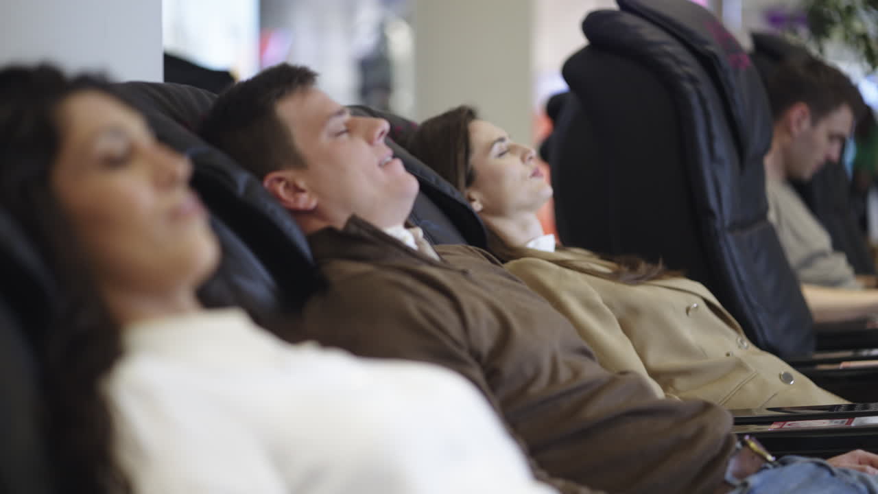 People Relaxing in Massage Chairs
