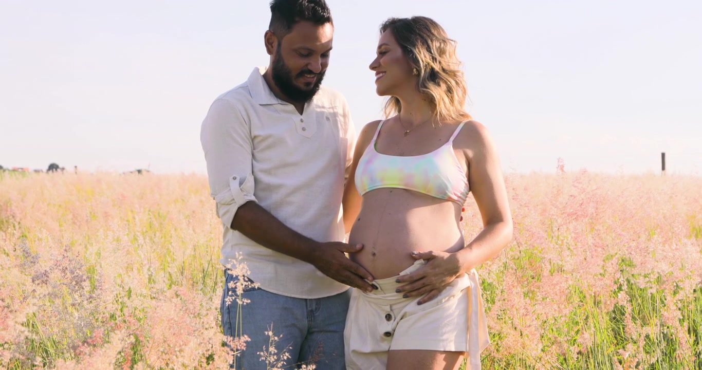 Marito che tiene la pancia della moglie incinta, il bambino si è mosso, la felicità di una nuova vita in arrivo