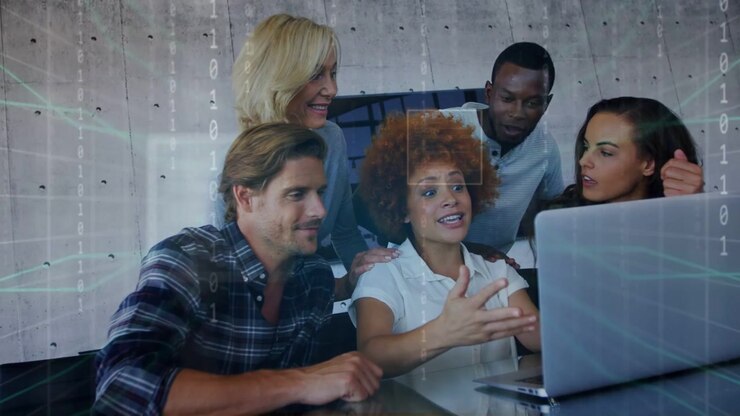 Lead woman typing on laptop and speaking, activating binary overlays for tech review, team reacting