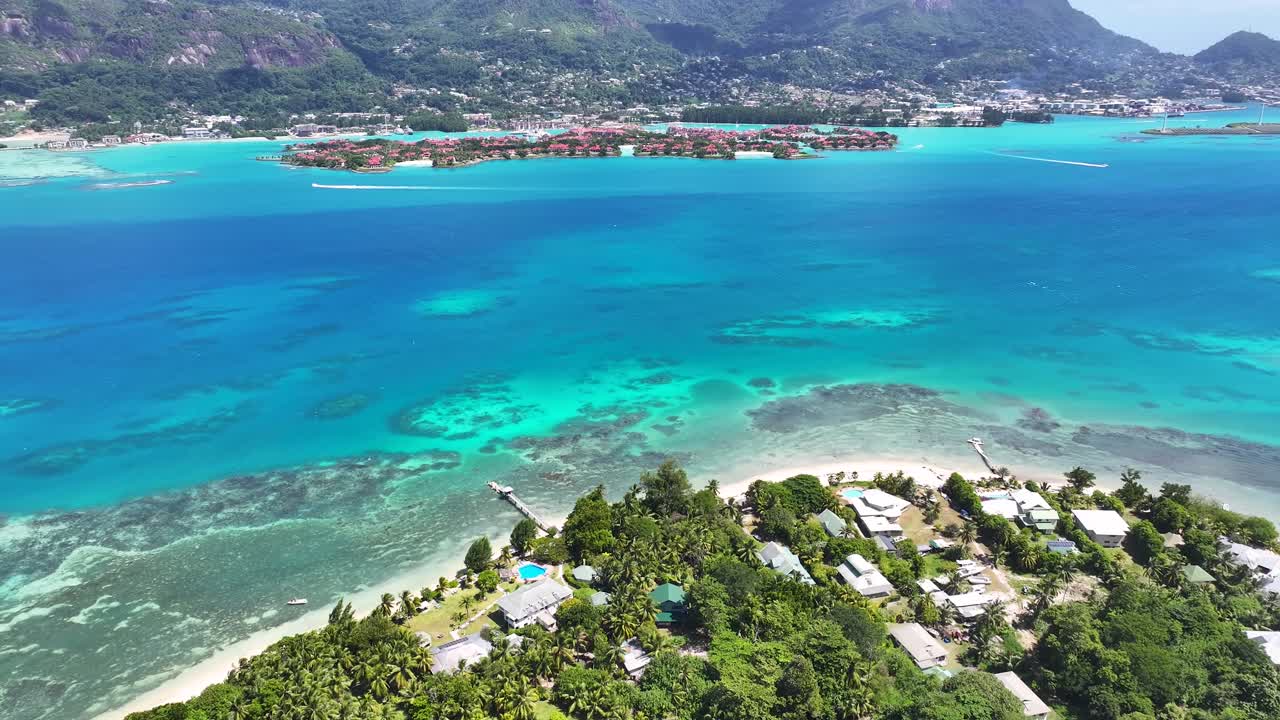 Aerial View of Tropical Island Coastline with Turquoise Waters and Resorts