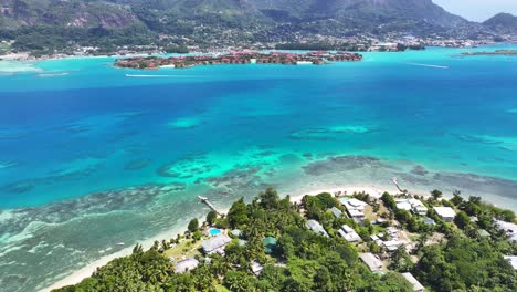 aerial view of tropical island coastline with turquoise waters and resorts