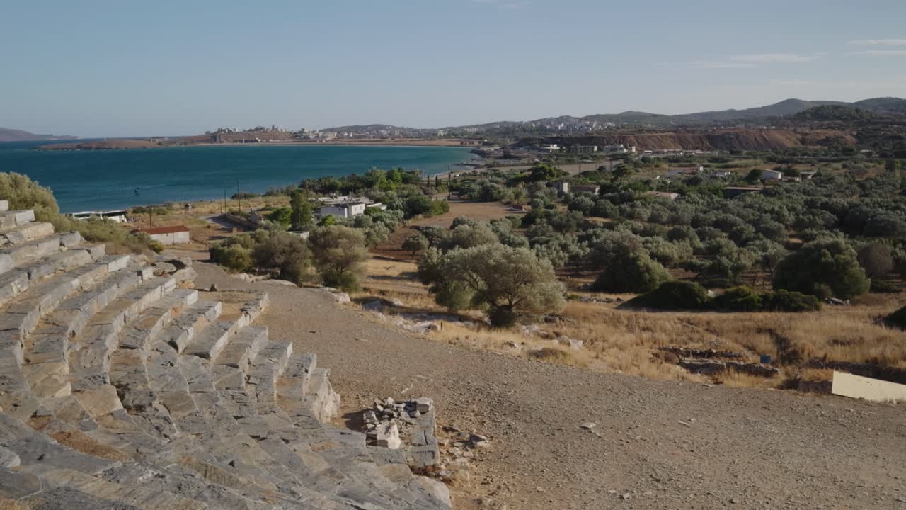 Stone amphitheater at Ancient Theatre of Thorikos with ocean in distance