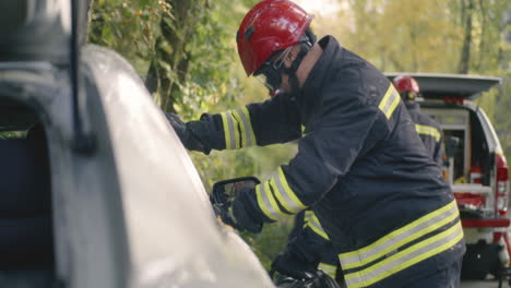 firefighters rescuing victims from a car accident