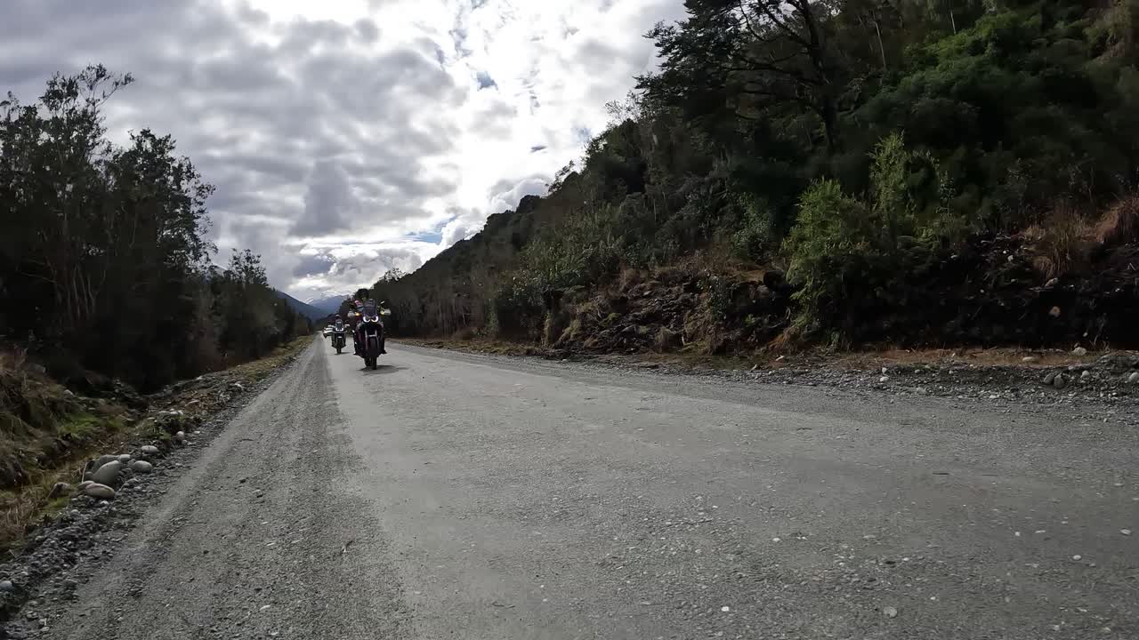 Group of adventure motorcyclists enjoying a gravel road. Chilean Patagonia