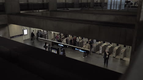 a top view of people walking through automatic turnstiles