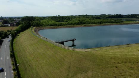 Water-supply-reservoir-sewage-contamination-social-issues-aerial-view-circling-rural-countryside-lake