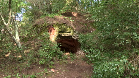Large-hole-in-a-rock-in-the-Monsanto-Forest-Park,-caused-by-natural-erosion-from-moisture
