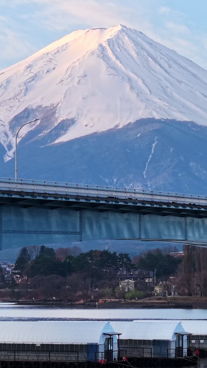 Aerial drone view of the Kawaguchiko-Ohashi bridge near the Fujikawaguchiko town in Japan with Mount Fuji on the background