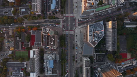 Aerial-birds-eye-overhead-top-down-descending-footage-of-road-intersection-in-town.-Autumn-colour-foliage.-Warsaw,-Poland