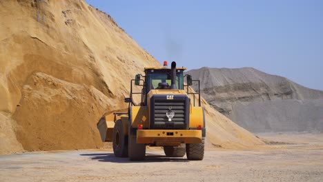 outdoor asphalt mixes station. industrial asphalt plant surrounded by piles of gravel