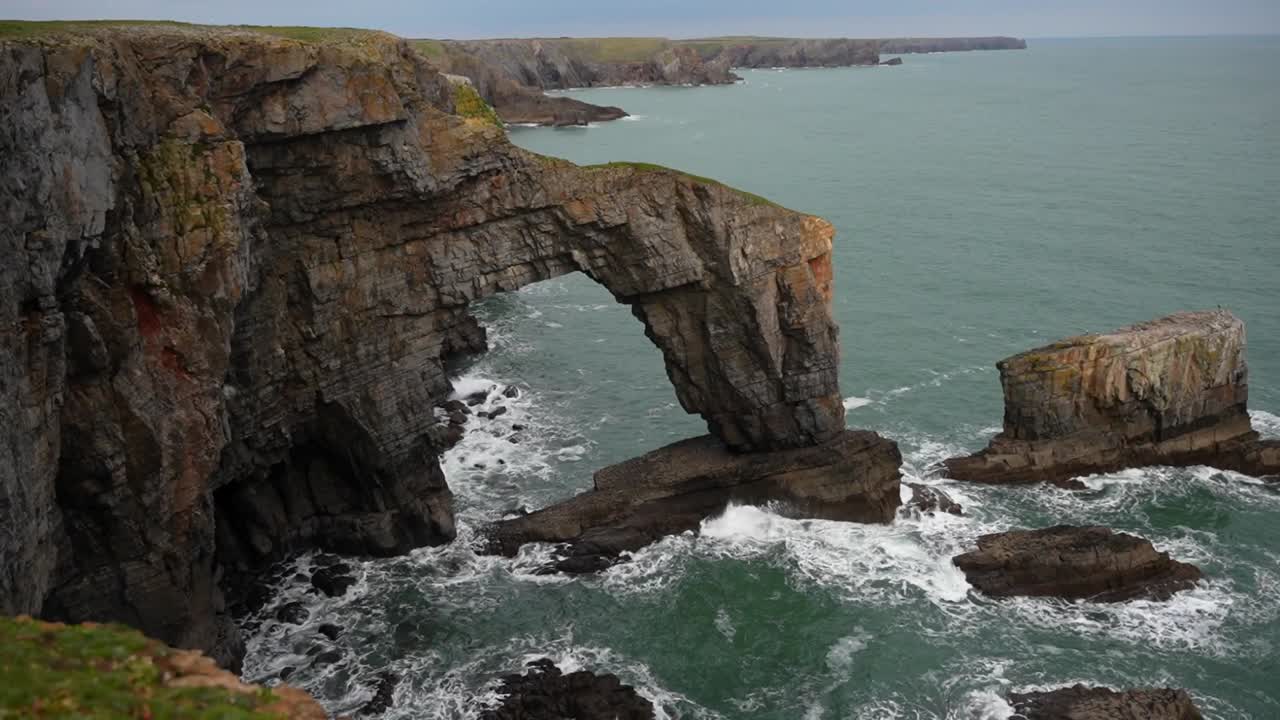 puente verde de gales, arco natural creado por la erosión de las olas del mar