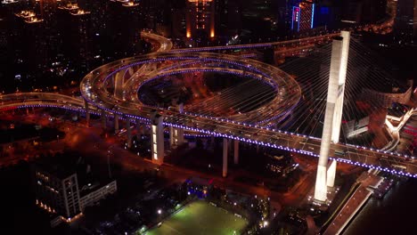 aerial video scene of traffic on nanpu bridge spiral road night sunset time with transportation on land concept, shanghai, china in 4k video