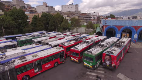 drone flying backwards across a fleet of metro buses