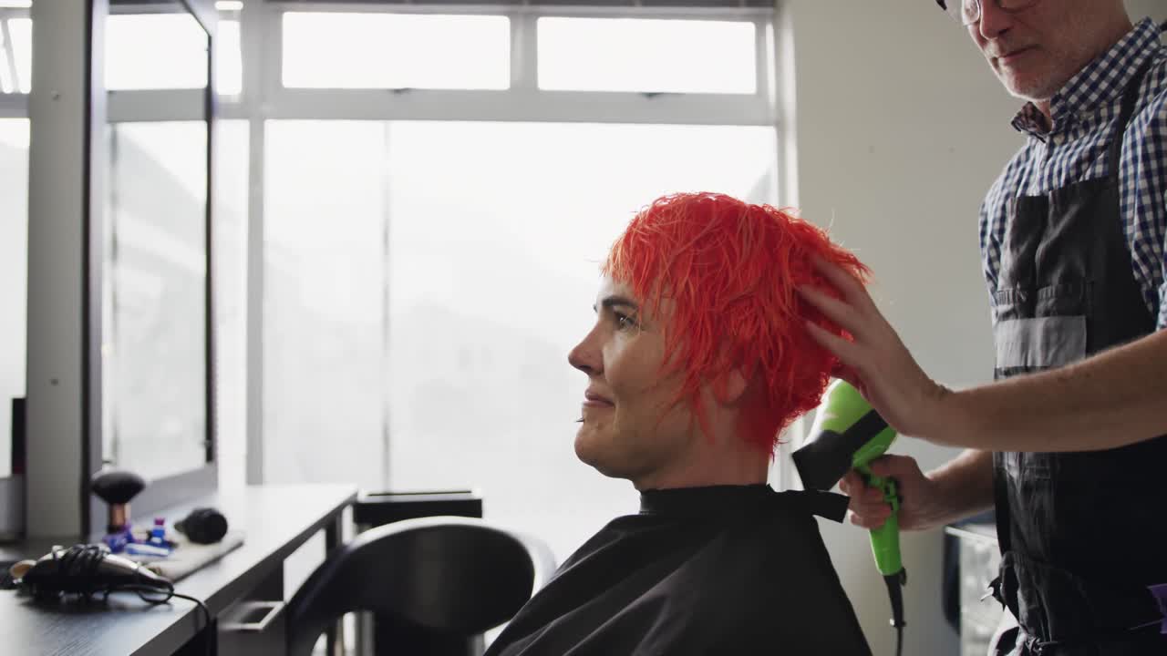 vista lateral mujer con el cabello seco por un peluquero