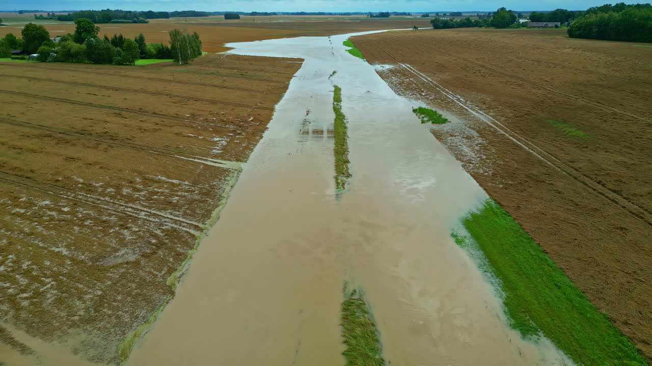 Flooded road in Latvia countryside, aerial dolly in, destroyed infrastructure