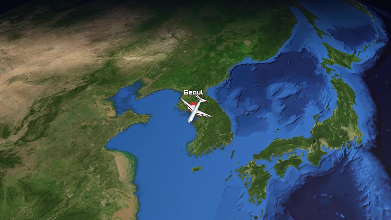 A digital animation tracks an airplane flying across a global map from Charlotte to Seoul