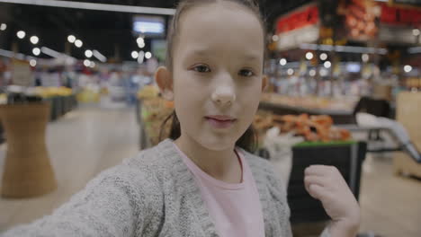 girl taking selfie in a supermarket