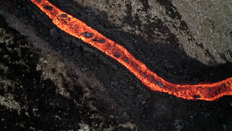 aerial pan of volcanic magma flowing through icelandic valley