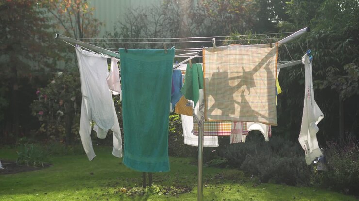 Clothes Drying Under The Sun, Hanging On Modern Clothesline Outside