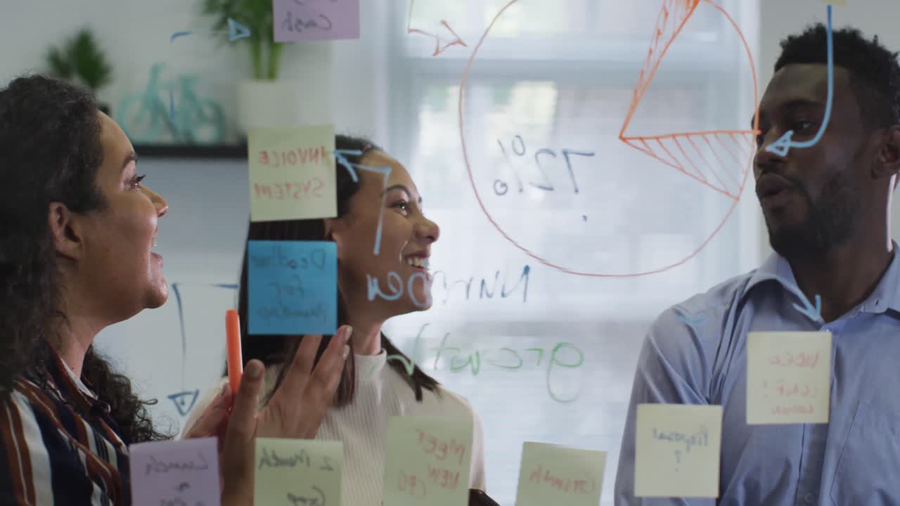 Happy diverse group of business people working together, brainstorming in modern office