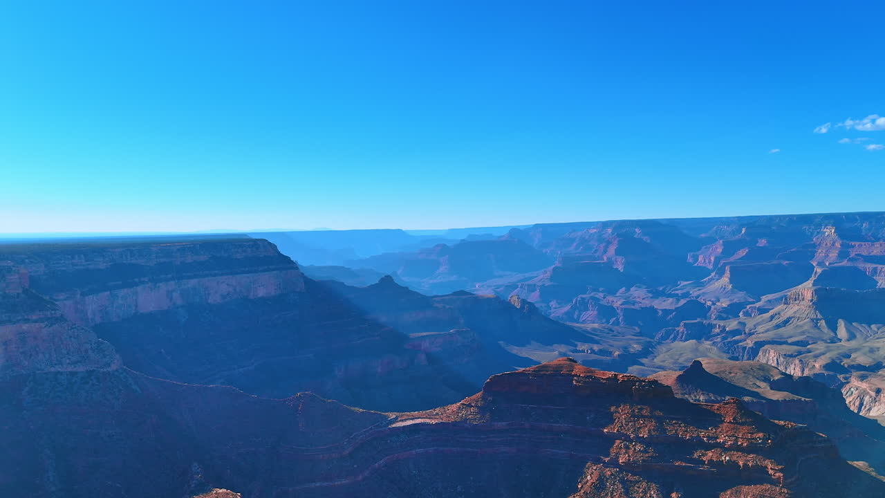 Deep layered canyons fading into the horizon. Multiple canyon layers fade into the horizon in soft blue tones