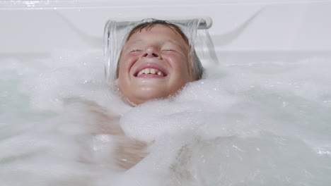 hydromassage is so exciting child having fun in spa tub