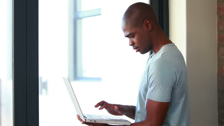 Smiling man using his laptop