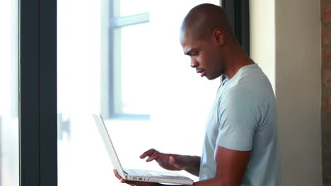 smiling man using his laptop